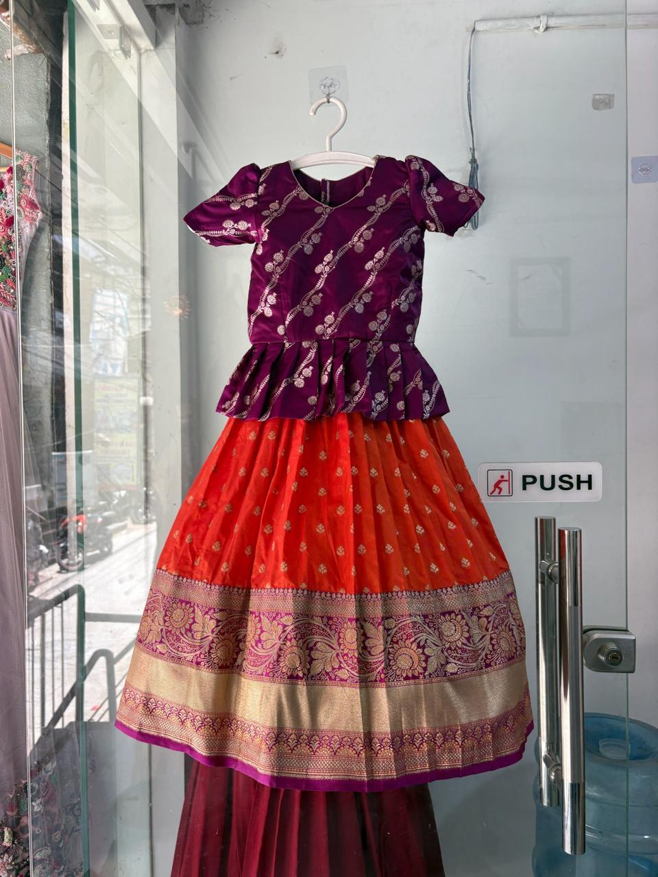 Maroon silk blouse with red lehenga skirt and gold embroidered border