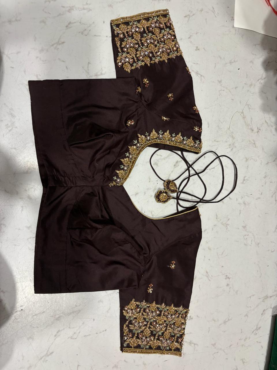 Dark maroon blouse with gold zari embroidery and ornamental tassels