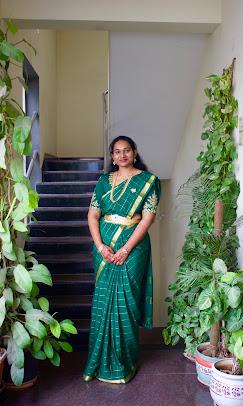 Green silk saree with gold zari work and traditional pleating