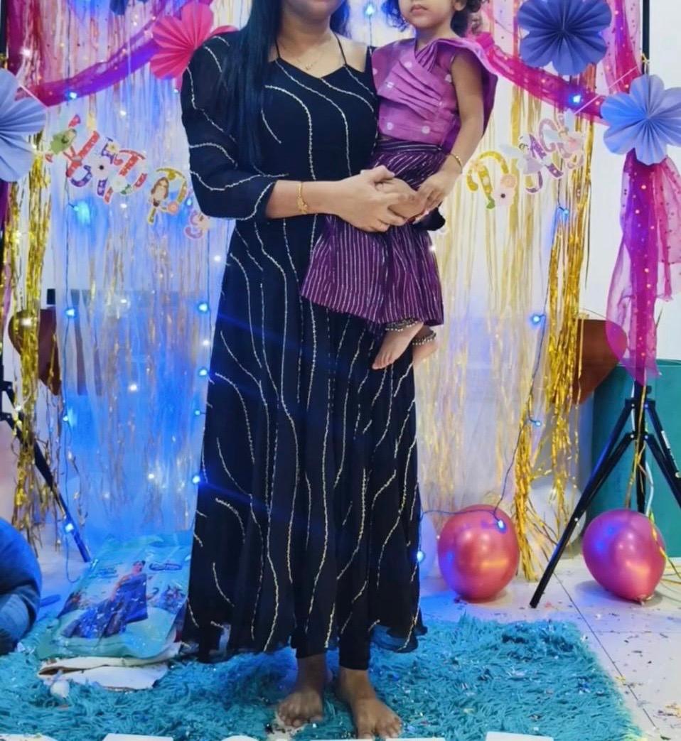 Black kurta with gold zari work and purple pleated skirt