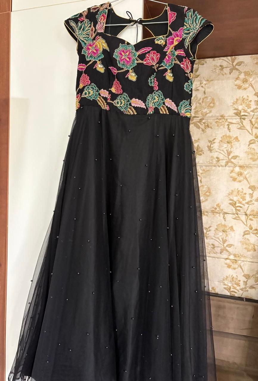 Black gown with colorful embroidered yoke and pearl embellishments