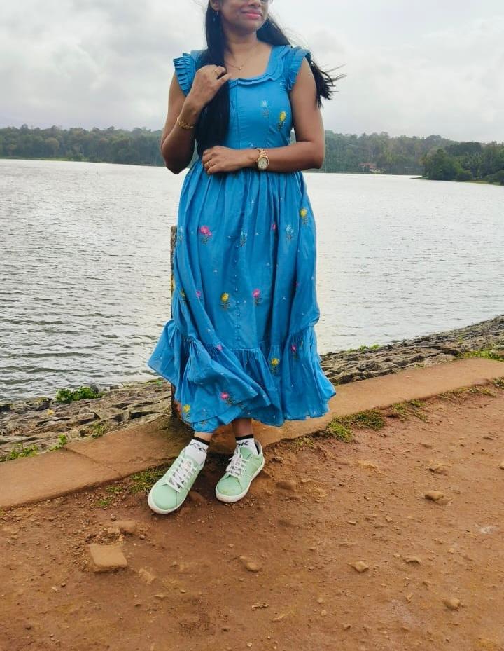 Blue embroidered floral maxi dress with ruffled shoulders and hem