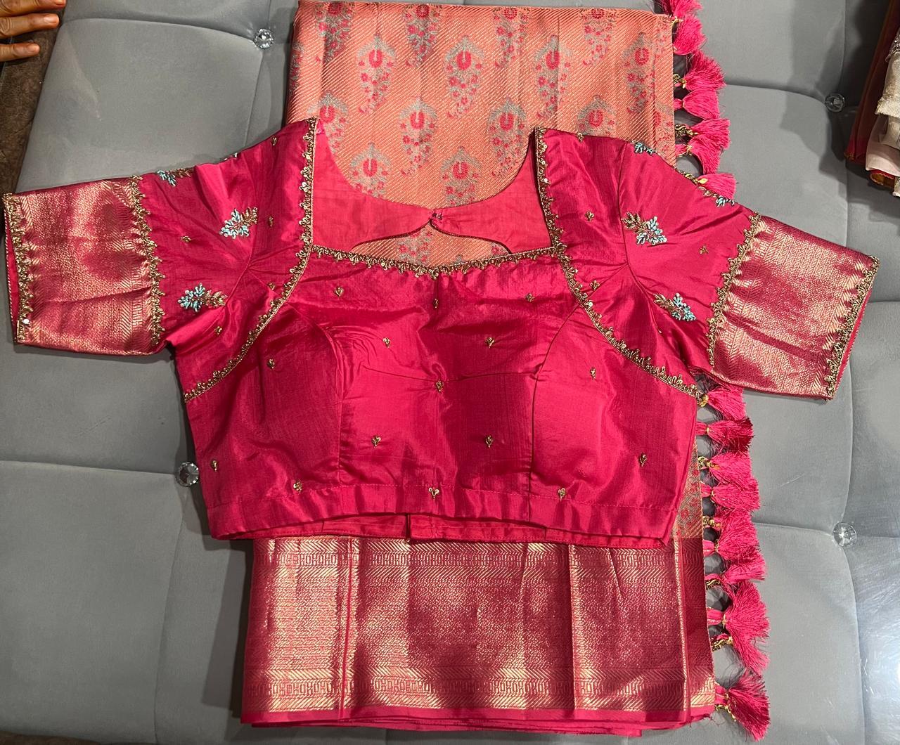 Bright pink bridal blouse with gold zari embroidery and matching saree