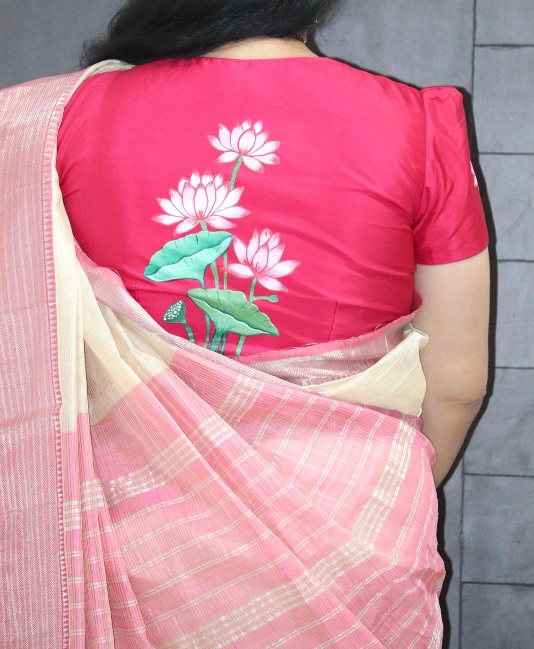 Pink blouse with white lotus flower embroidery and matching checkered saree