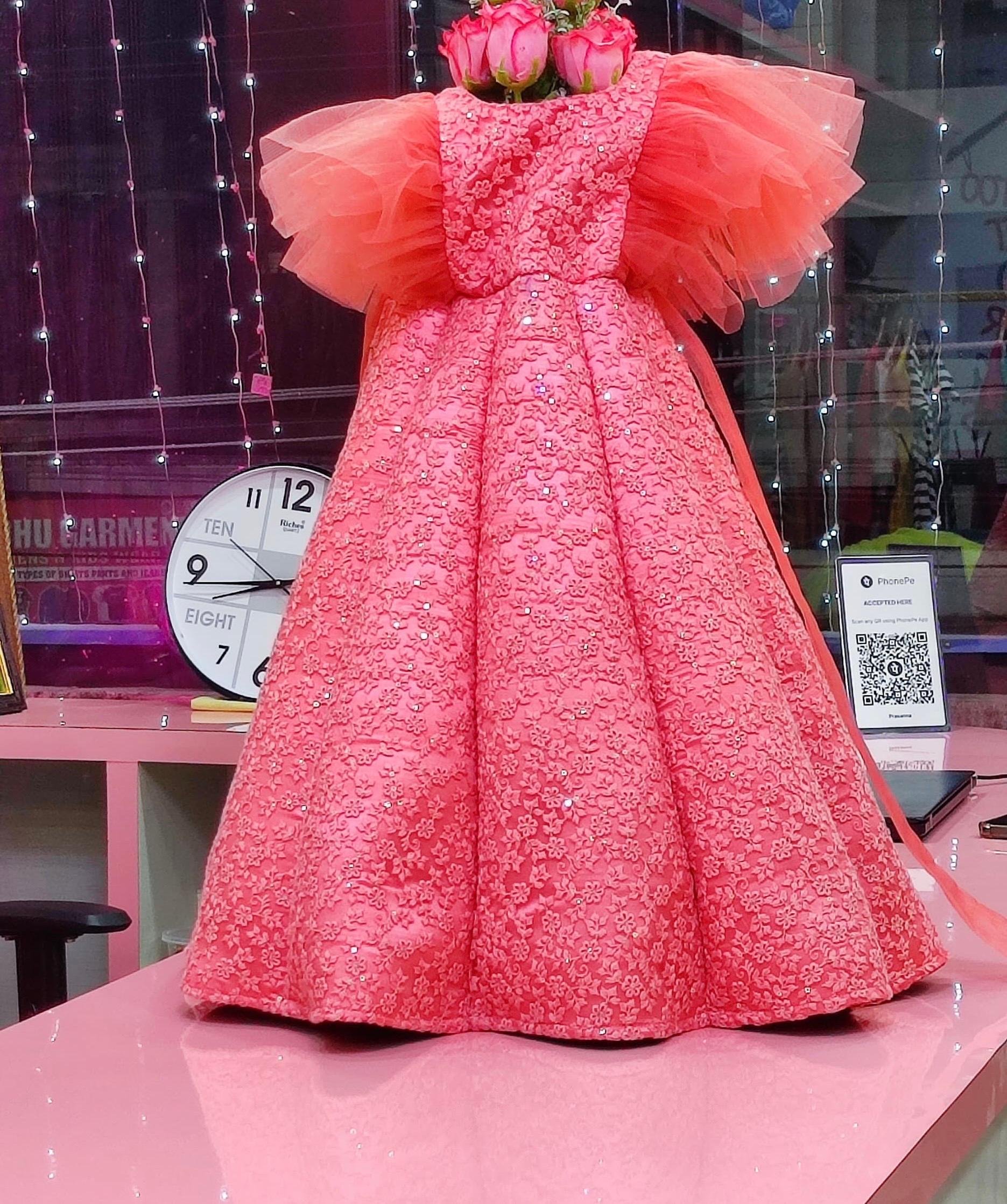 Coral pink gown with textured lace embroidery and voluminous tulle shoulders