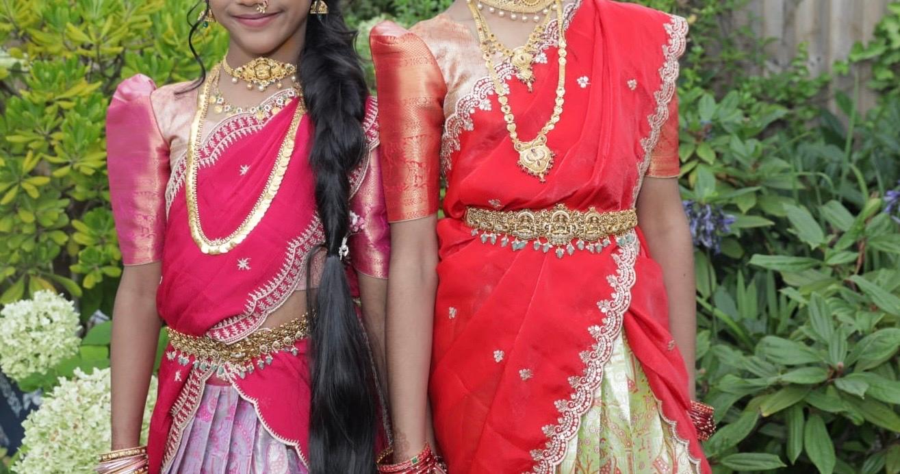 Pink and red traditional half sarees with ornate gold embroidery and beadwork