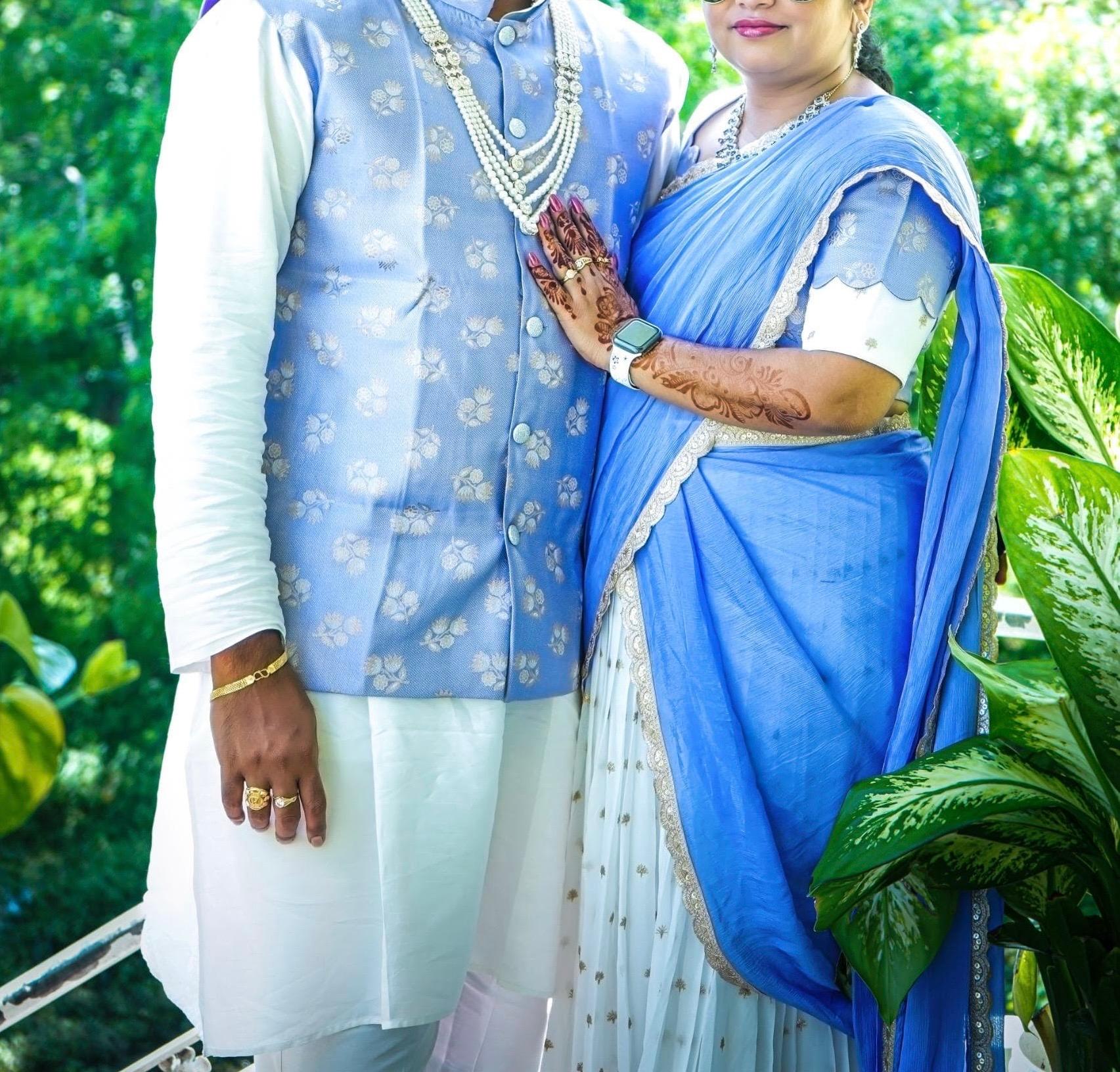 Blue silk saree with white blouse and pearl necklace, traditional Indian wedding attire