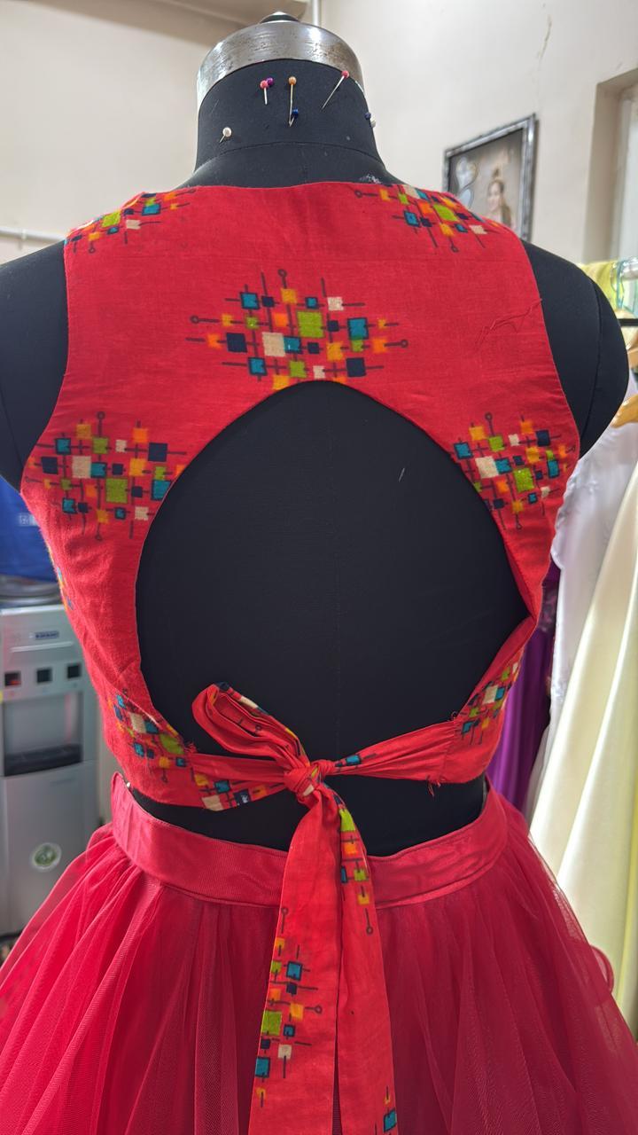 Red party wear gown with colorful geometric embroidery and open back