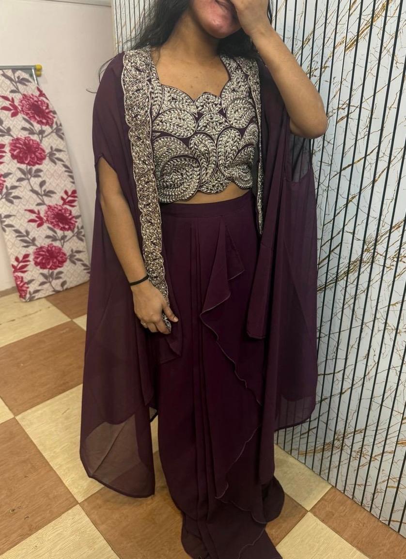 Maroon chiffon saree with ornate embroidered blouse and sheer drape