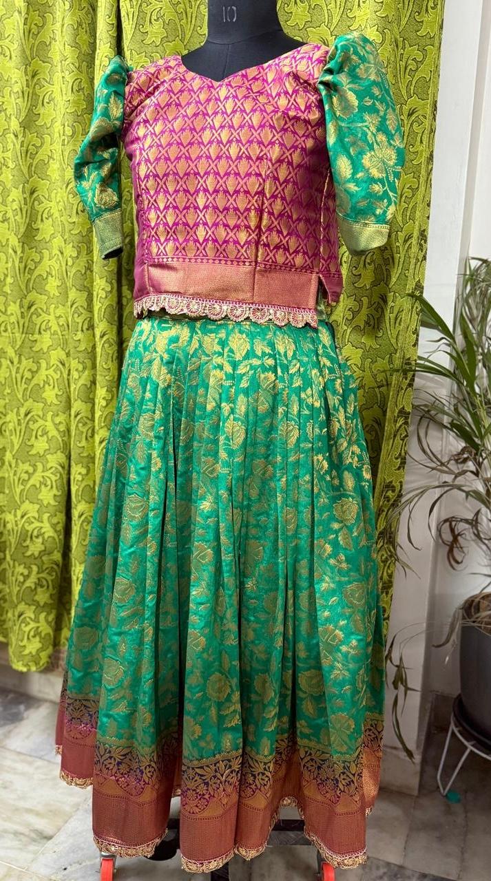 Pink and green silk lehenga with gold zari embroidery and lace border