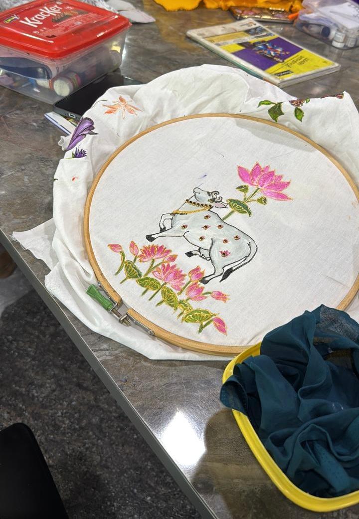 White embroidered hoop art with hippo and pink lotus flowers design