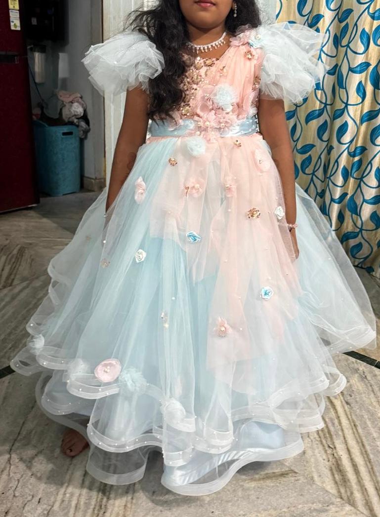 Pastel tulle gown with floral 3D embellishments and ruffled shoulders