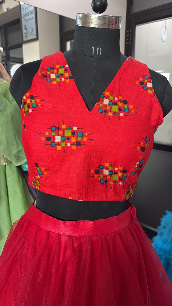 Red blouse with vibrant multicolor geometric embroidery pattern