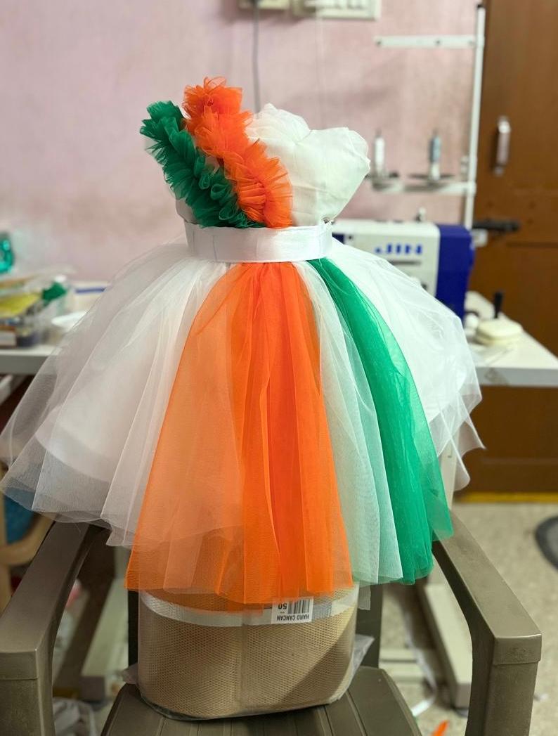 Tricolor tulle dress with green, orange, white stripes and pom-pom details