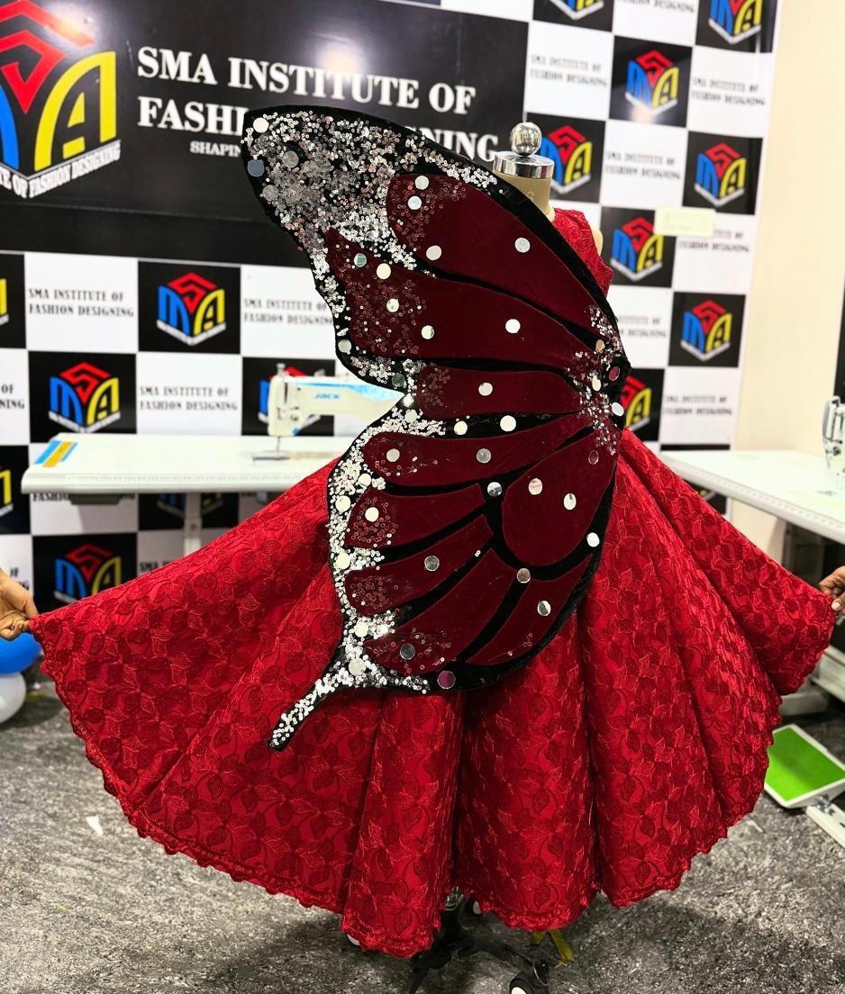 Red gown with butterfly wing design and pearl embellishments