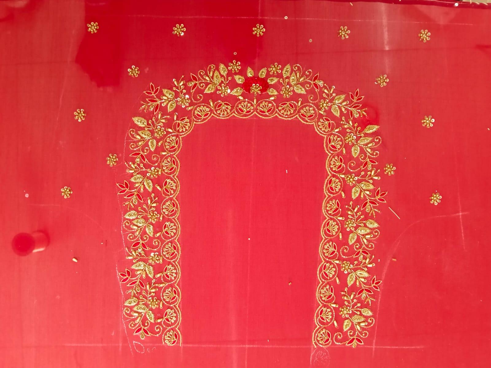 Red fabric with gold zari floral embroidery border design