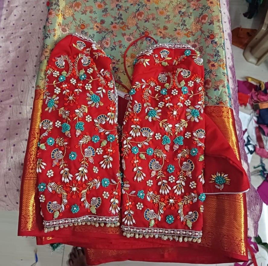 Red bridal blouse with floral embroidery and pearl beadwork
