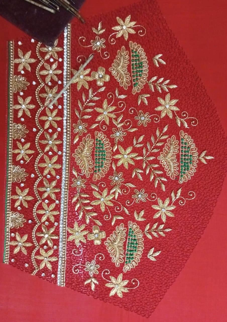 Red blouse with gold zari floral embroidery and green accents