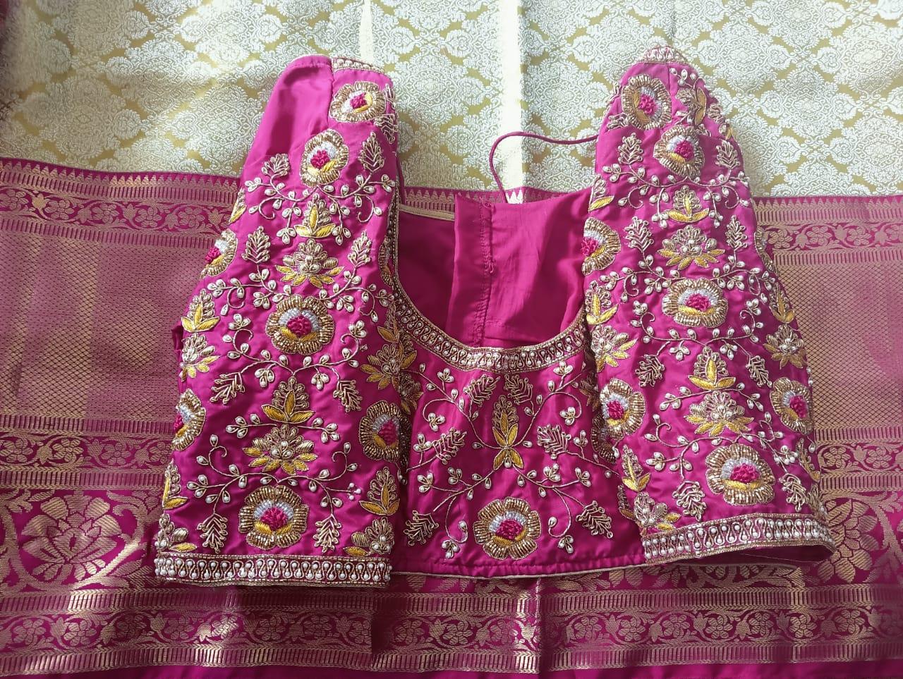 Magenta bridal blouse with intricate gold and floral maggam work embroidery