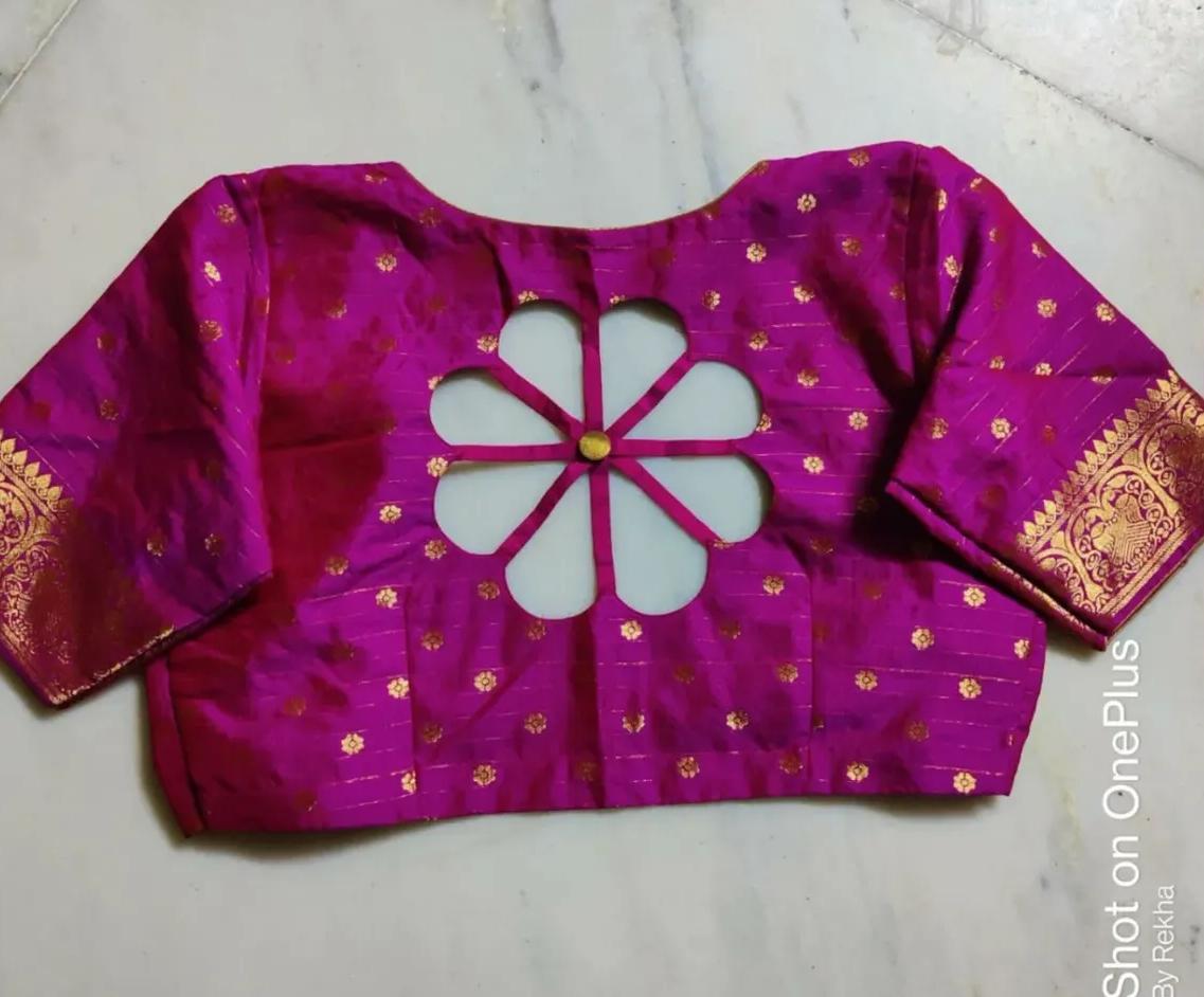 Magenta silk blouse with gold zari work and floral cutwork design