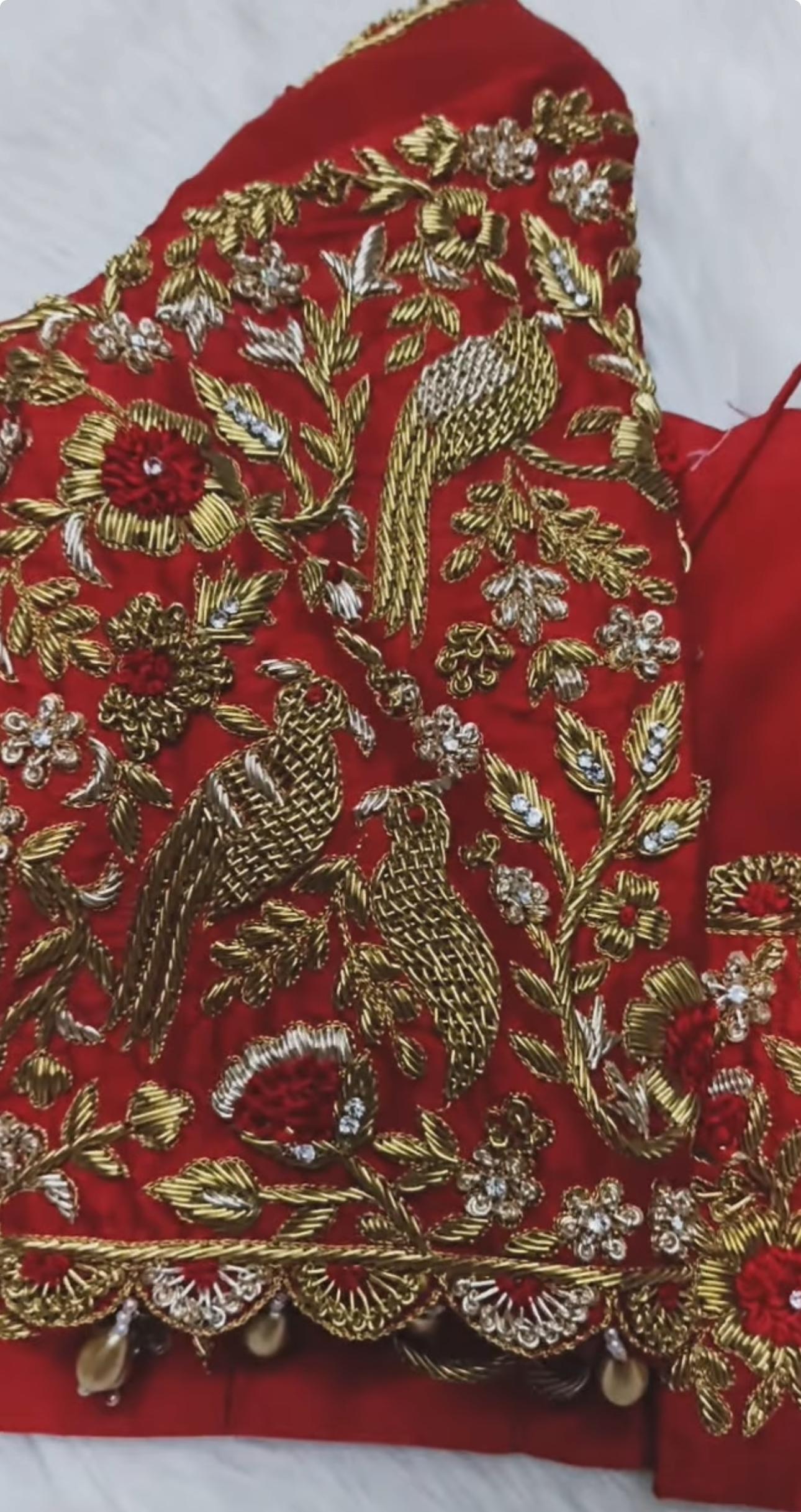 Red bridal maggam work blouse with peacock bird embroidery