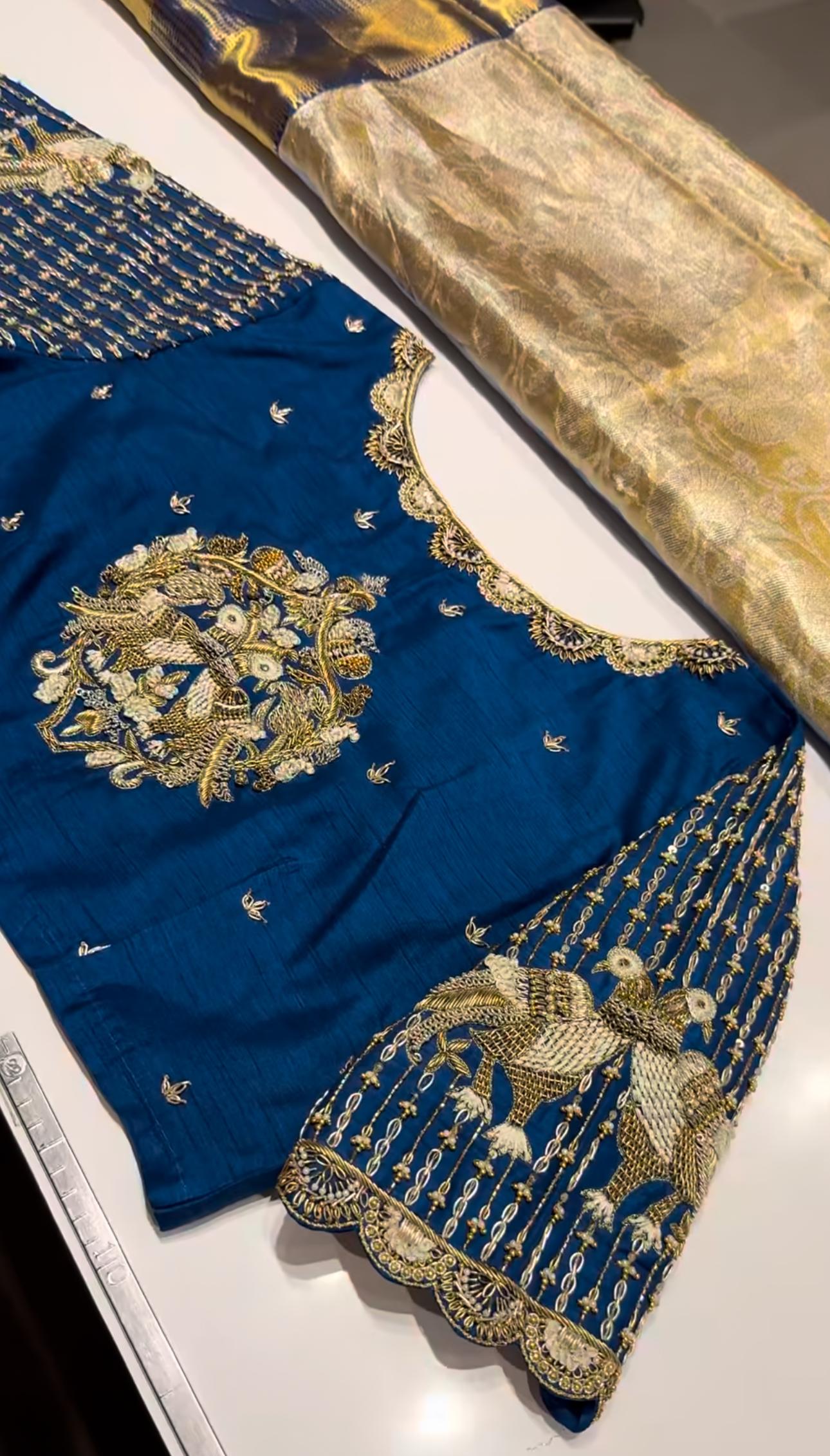 Elegant royal blue bridal blouse featuring intricate zari maggam work, handcrafted designer sleeves, and premium silk finish for weddings and festive occasions.