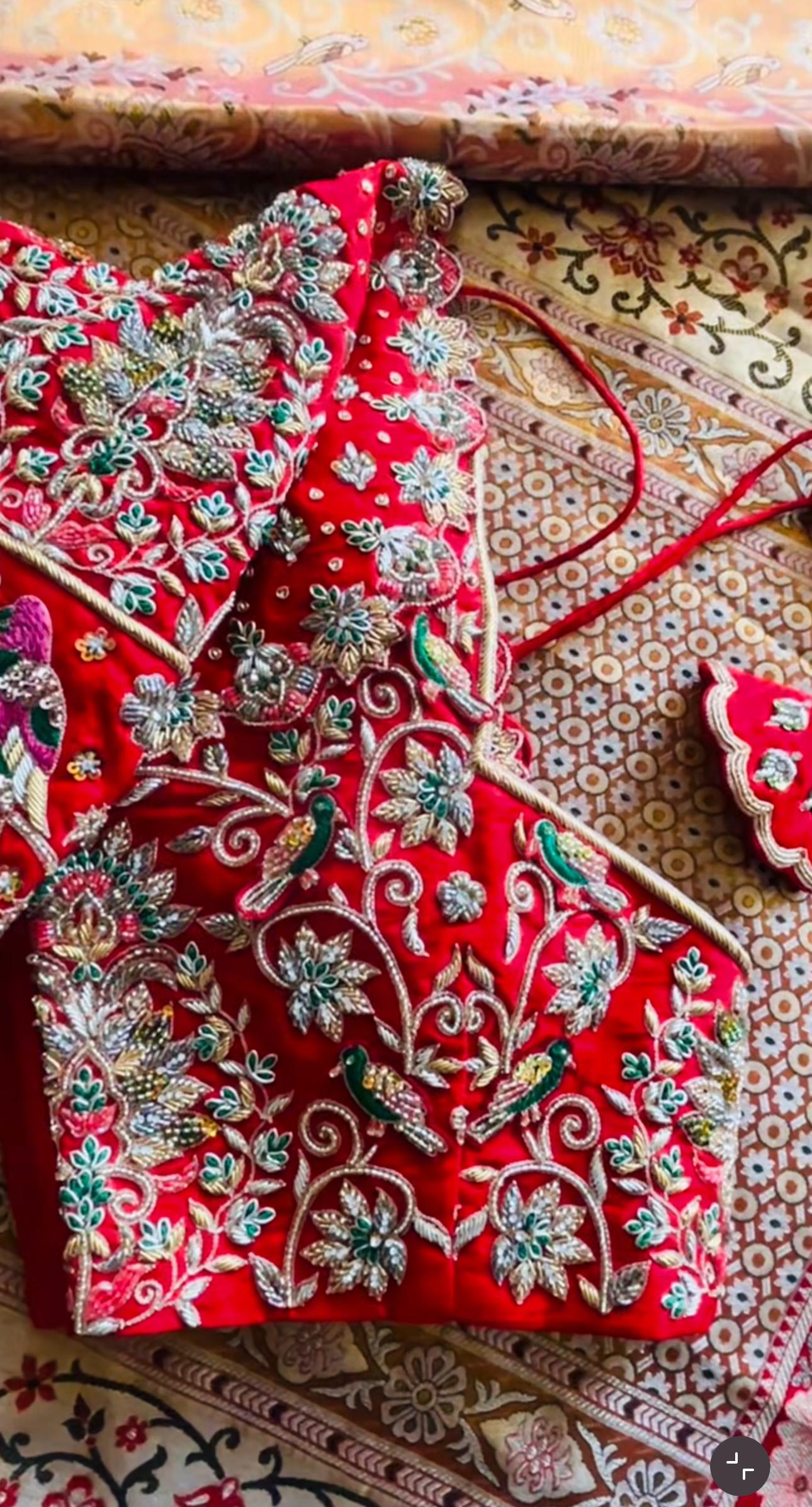 Red bridal maggam blouse with colorful parrot and floral embroidery design