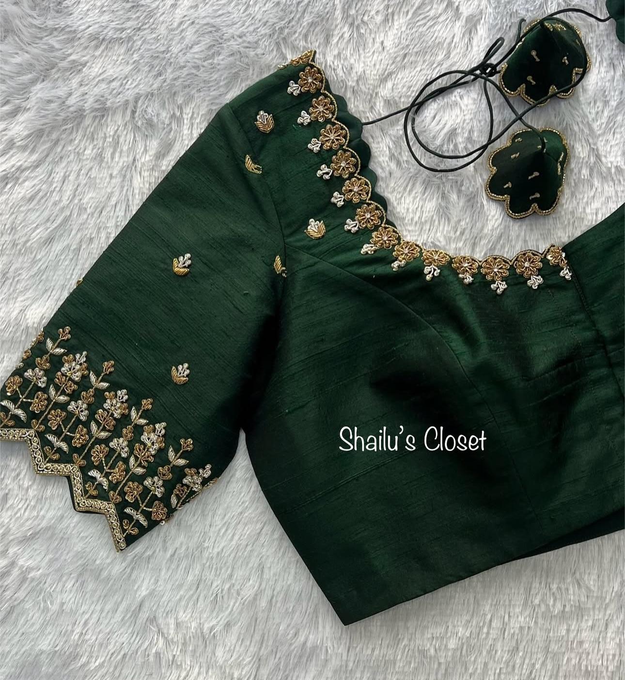 Dark green designer blouse featuring detailed embroidery on sleeves and neckline, perfect for partywear sarees.