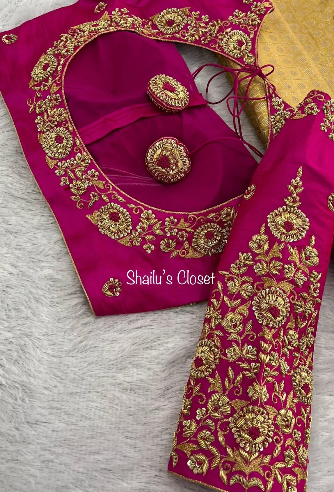 Rich hot pink bridal blouse featuring dense maggam embroidery and intricate gold detailing, perfect for grand wedding occasions.