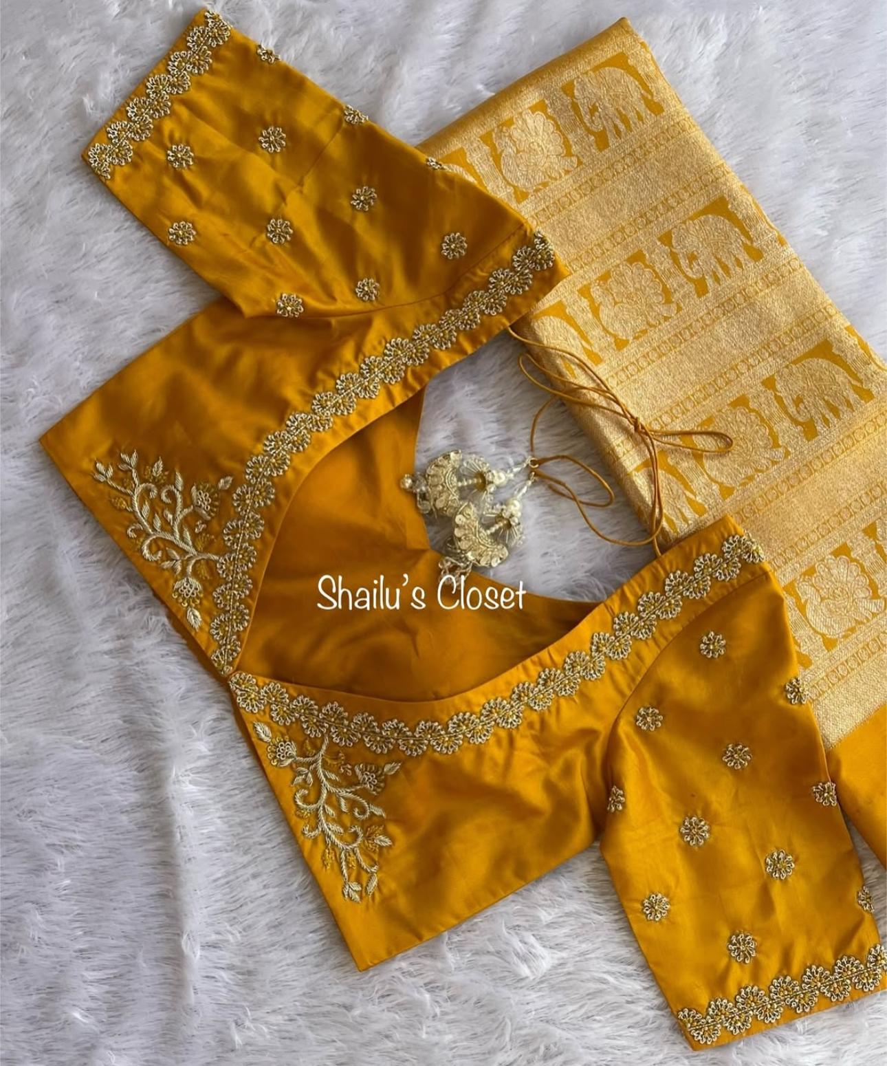 Mustard bridal blouse featuring heavy maggam work embroidery along the neckline and sleeves, designed for traditional weddings and festive occasions.