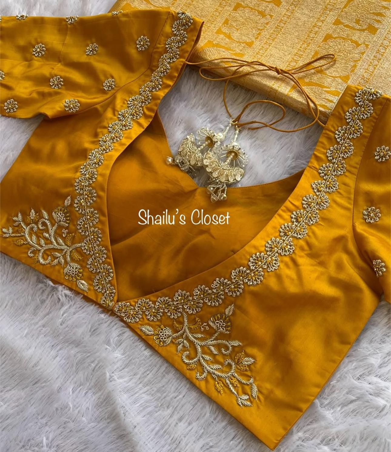 Mustard silk blouse featuring elegant maggam work along the neckline with stone and thread embroidery, ideal for festive and traditional wear.