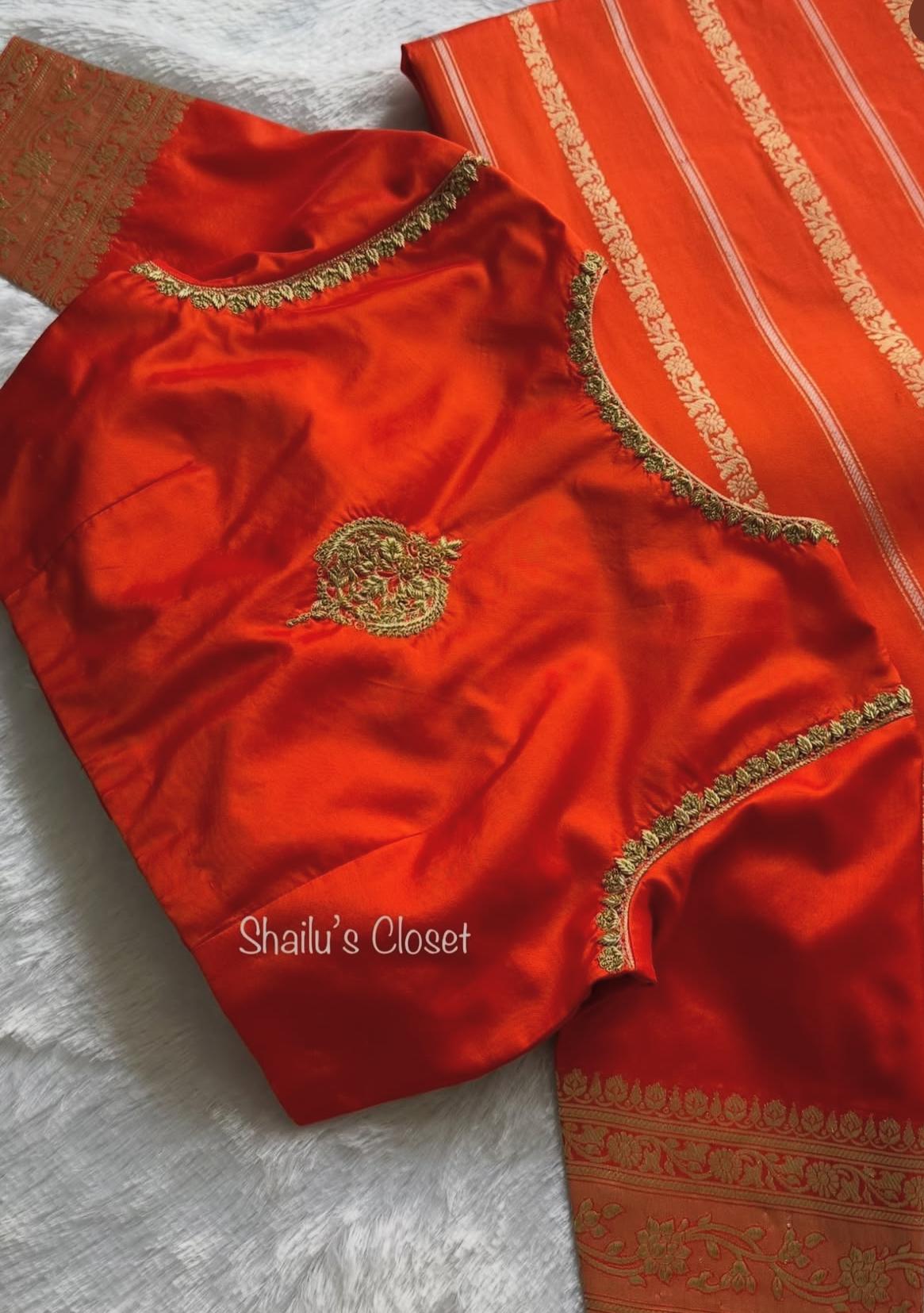 Vibrant orange silk blouse with classic detailing, perfect for festive saree styling.