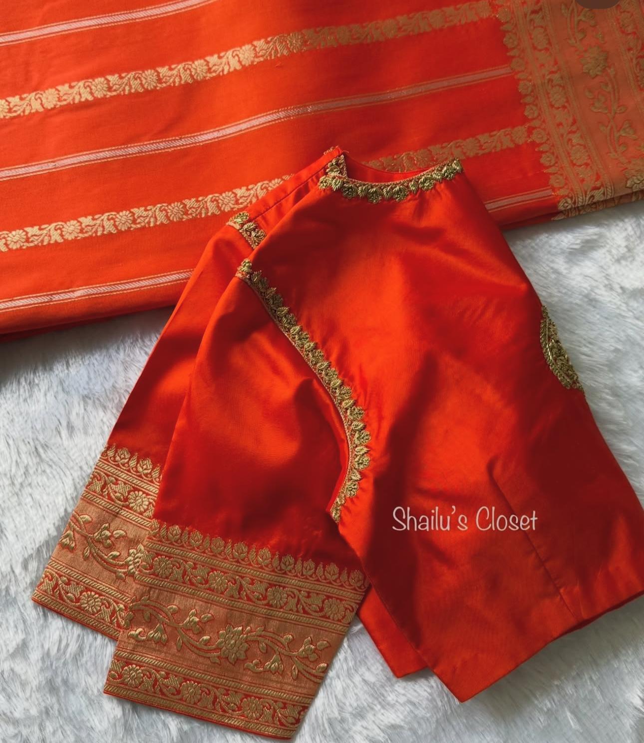 Bright orange silk blouse with classic woven borders, suitable for festive and cultural events.