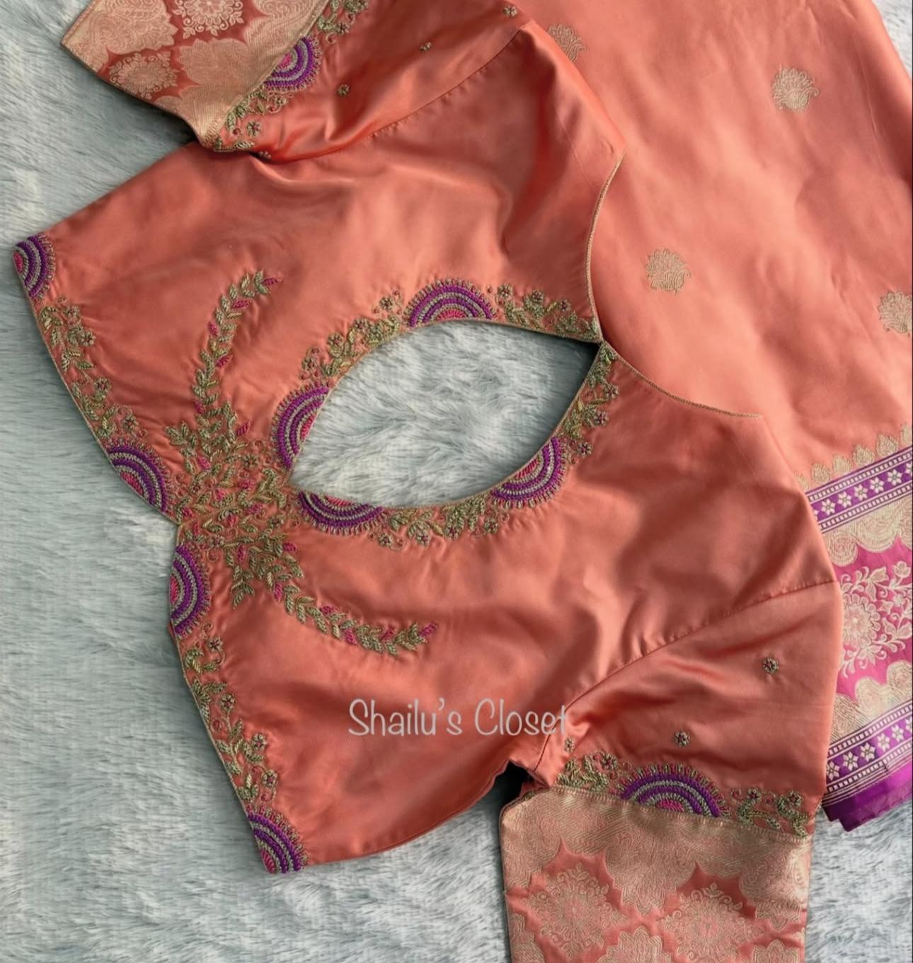 Peach designer blouse with intricate embroidery around the back neckline, suitable for festive and wedding wear.