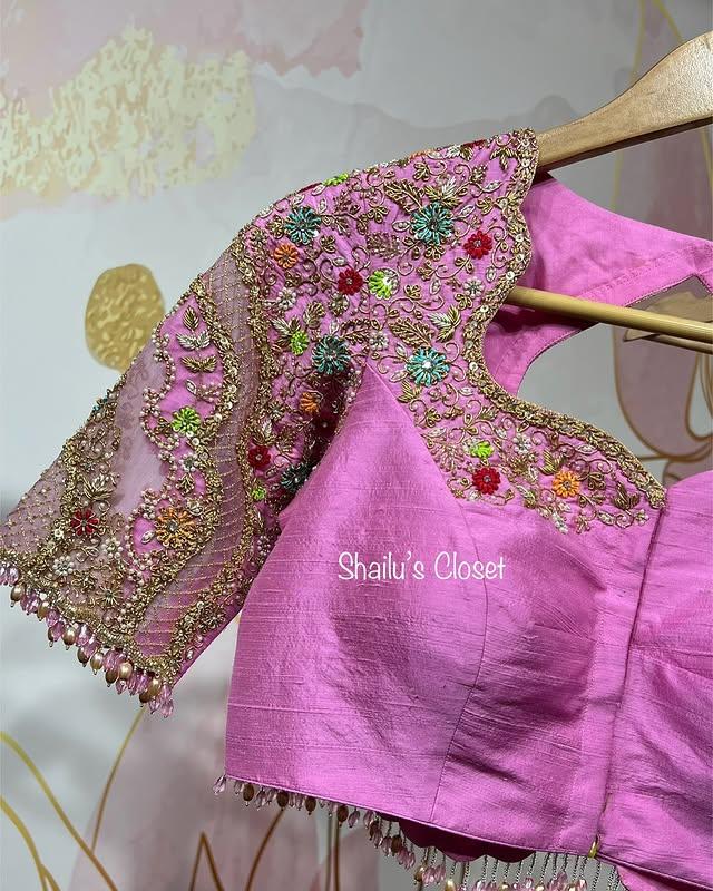 Elegant pink blouse featuring floral maggam embroidery on the sleeves, suitable for festive and wedding celebrations.