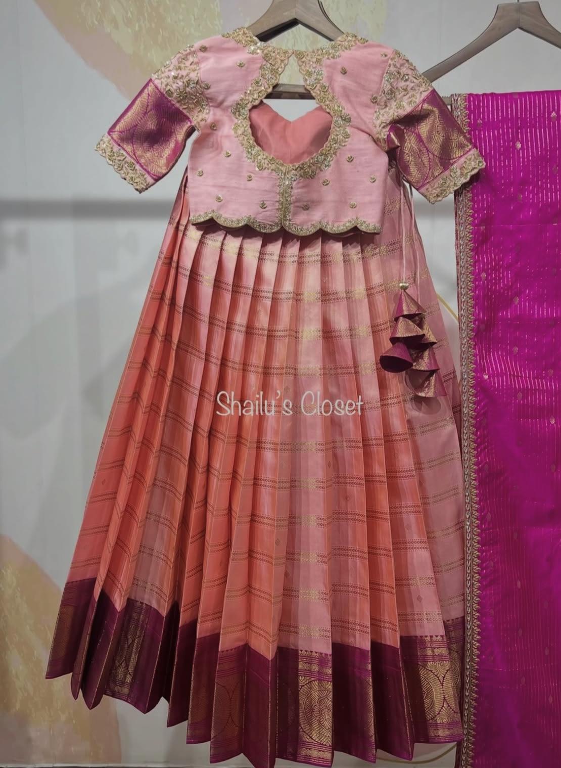 Elegant pink lehenga set featuring a heavily embroidered blouse and pleated skirt, perfect for weddings and festive celebrations.