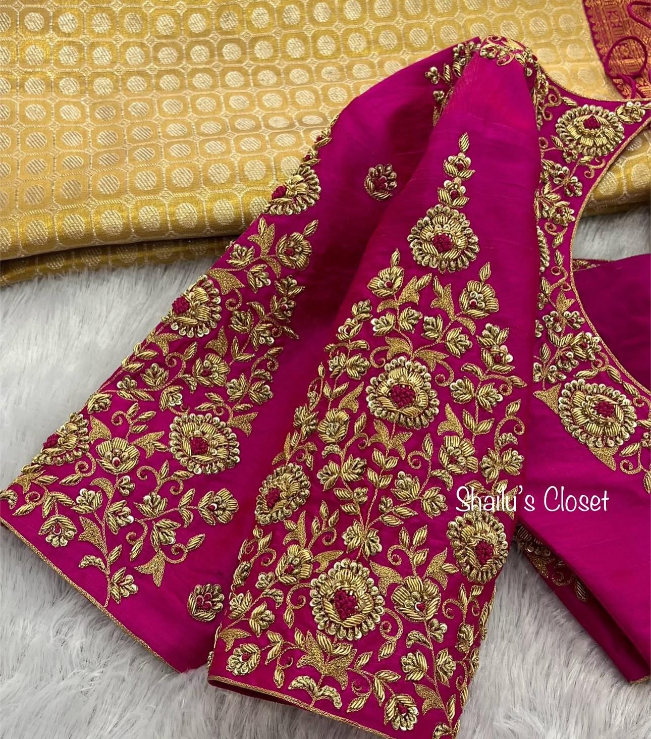 Rani pink blouse sleeve decorated with detailed heavy maggam embroidery, ideal for bridal wear.