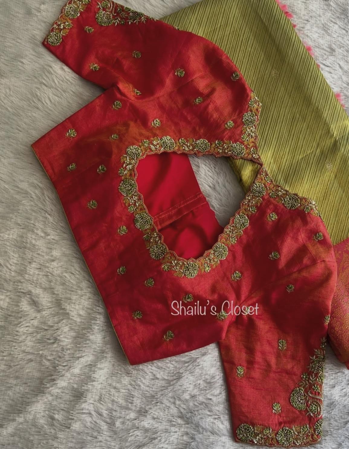 Rich red bridal blouse featuring intricate maggam embroidery around the back neckline, perfect for wedding ceremonies.