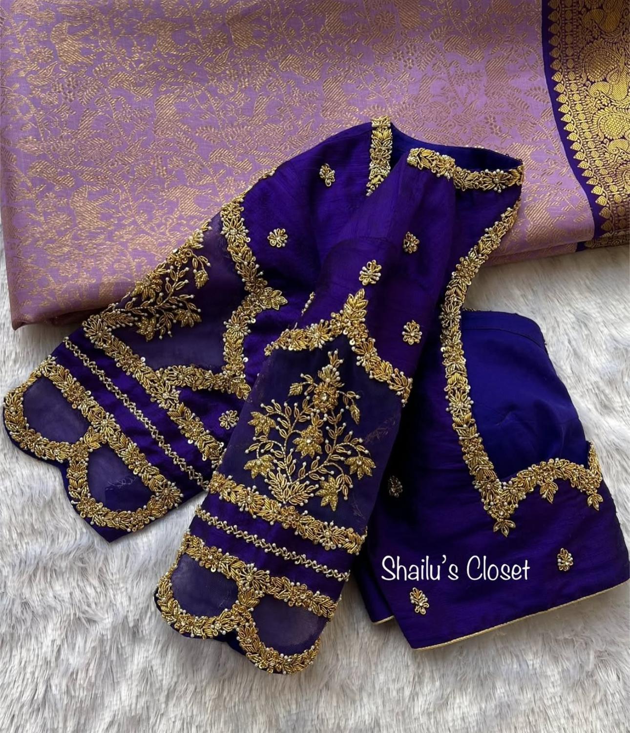 Royal blue premium bridal blouse featuring heavy maggam work embroidery on the sleeves and back, designed for grand wedding and reception looks.