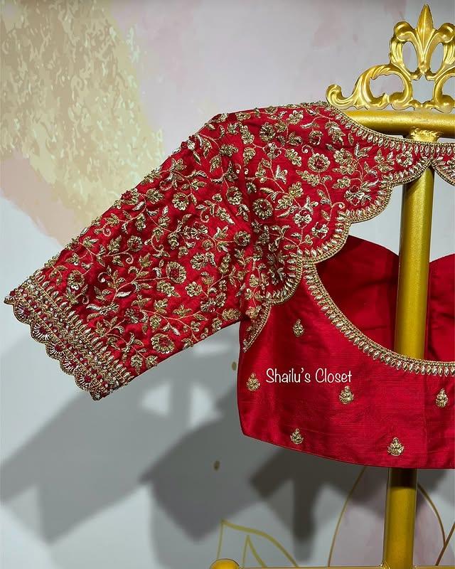 Red blouse sleeve featuring intricate floral maggam embroidery, ideal for bridal,festive and partwayer outfits.