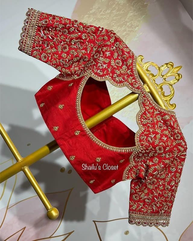 Red blouse sleeve with dense maggam embroidery and detailed patterns, designed for bridal and festive occasions.