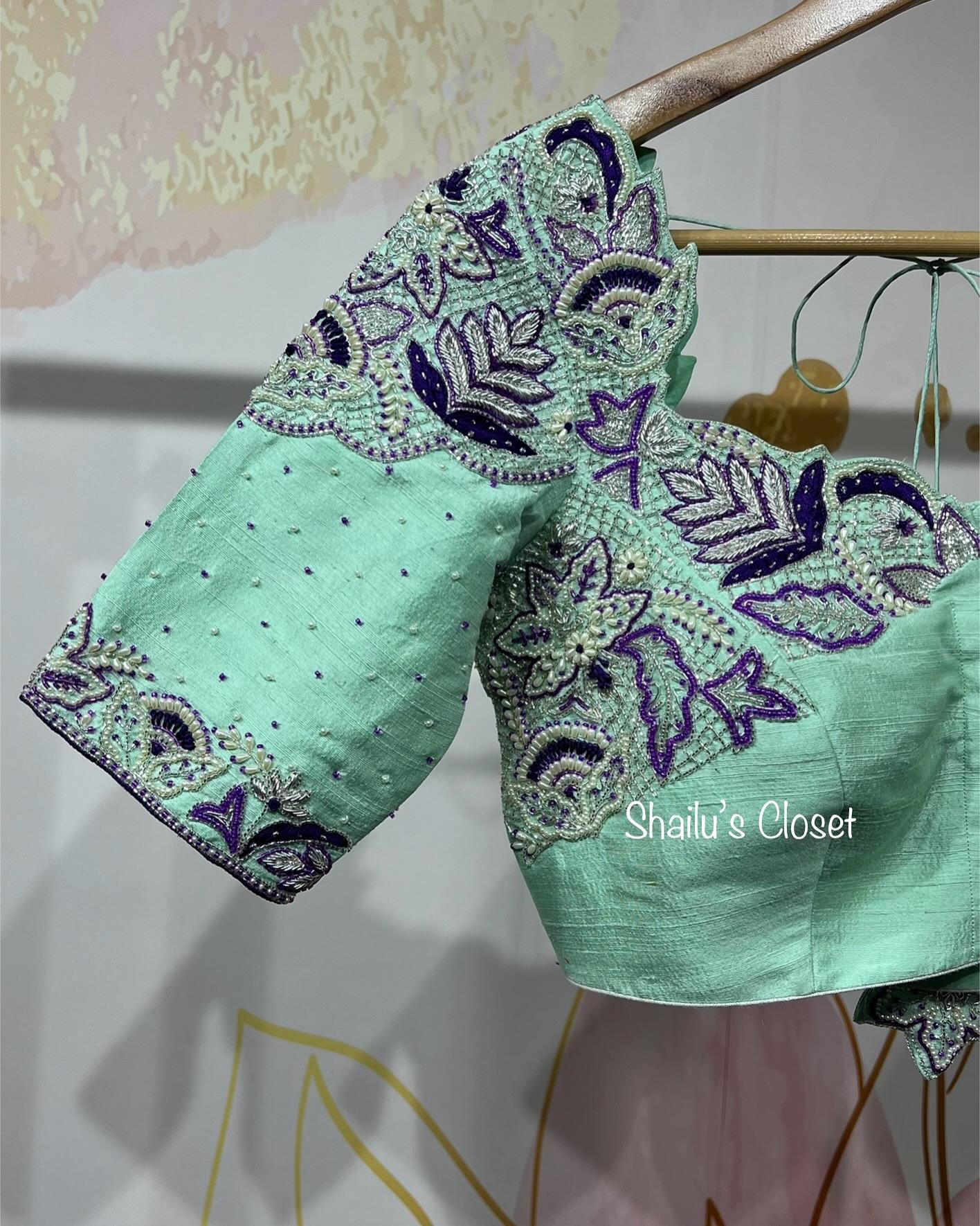 Mint blouse sleeve decorated with detailed maggam embroidery, ideal for traditional and festive saree combinations.