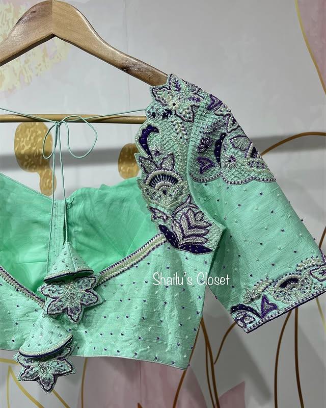 Mint green blouse featuring intricate floral maggam embroidery on the sleeves, perfect for festive and elegant saree looks.