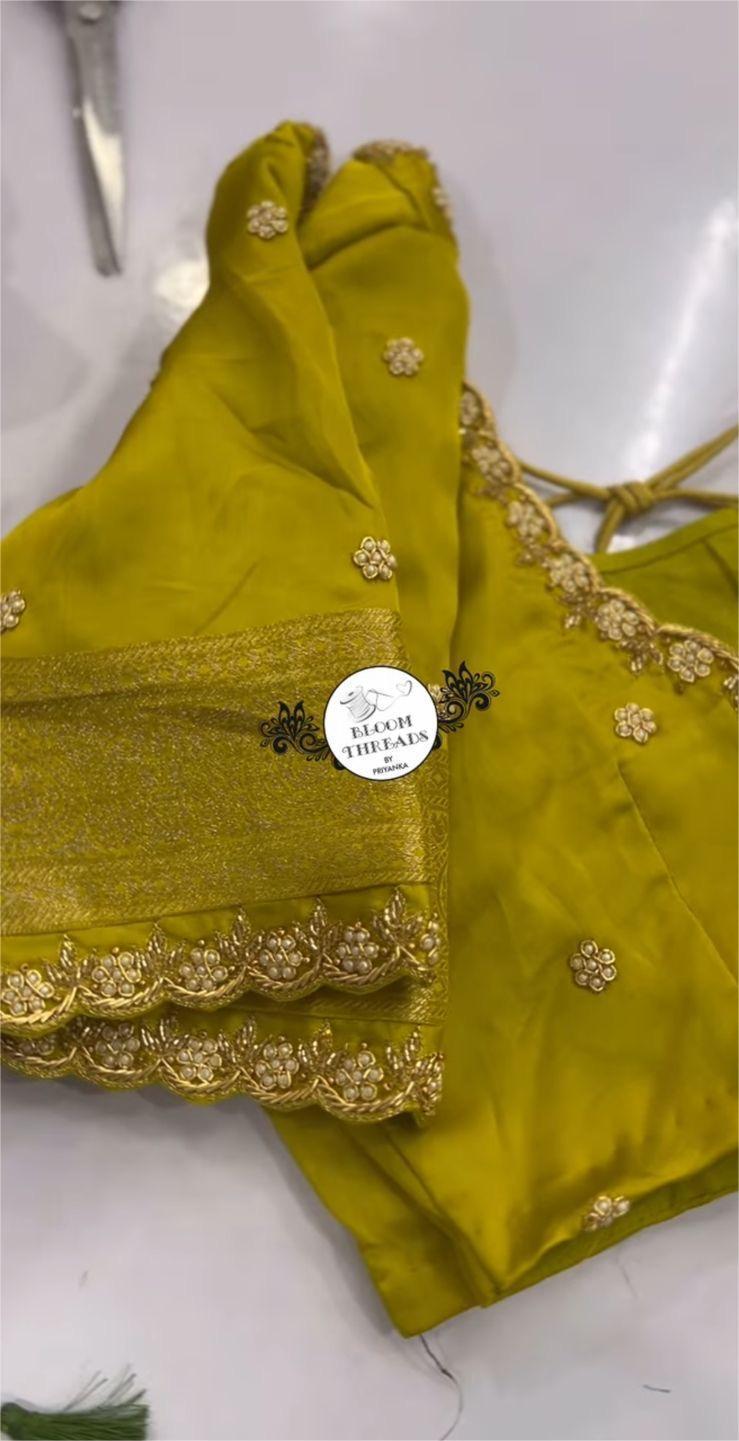 Bright yellow blouse featuring subtle maggam embroidery along the borders, perfect for festive and traditional sarees.
