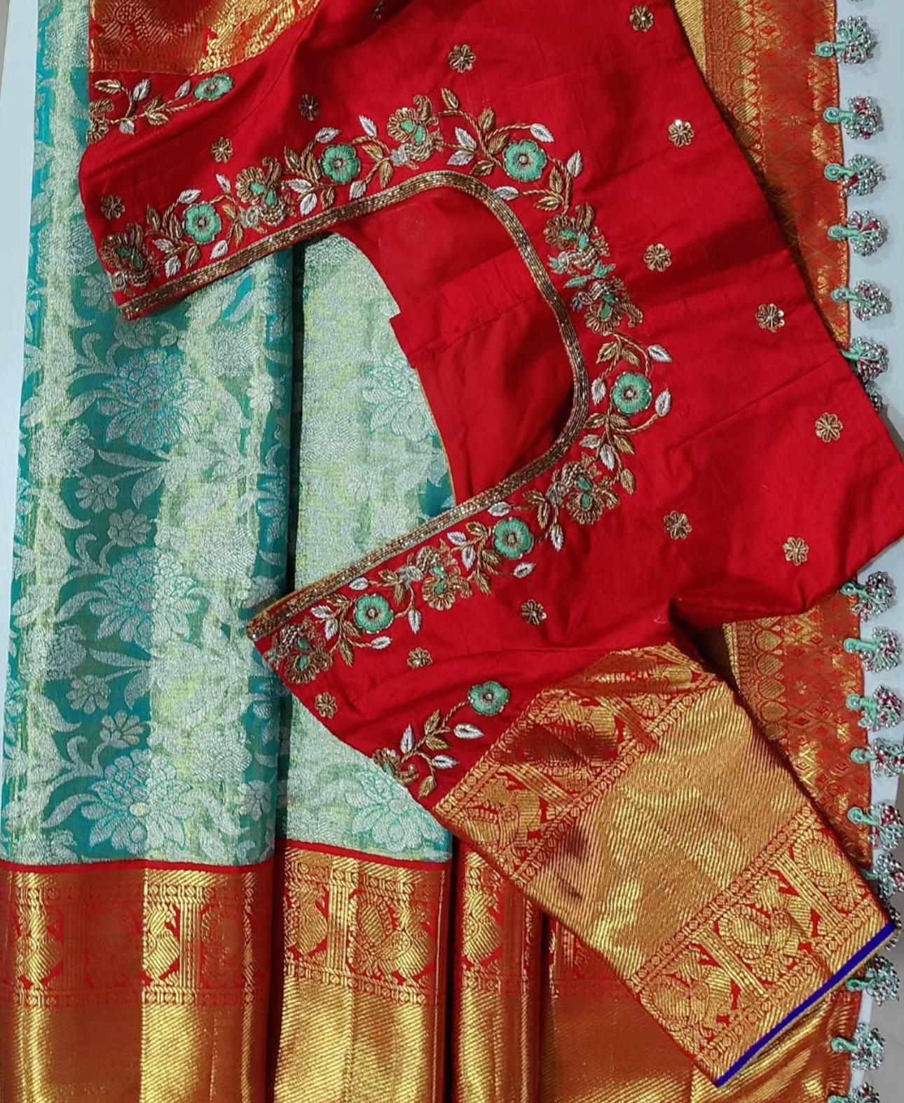 Red bridal blouse with floral maggam work paired with silk saree