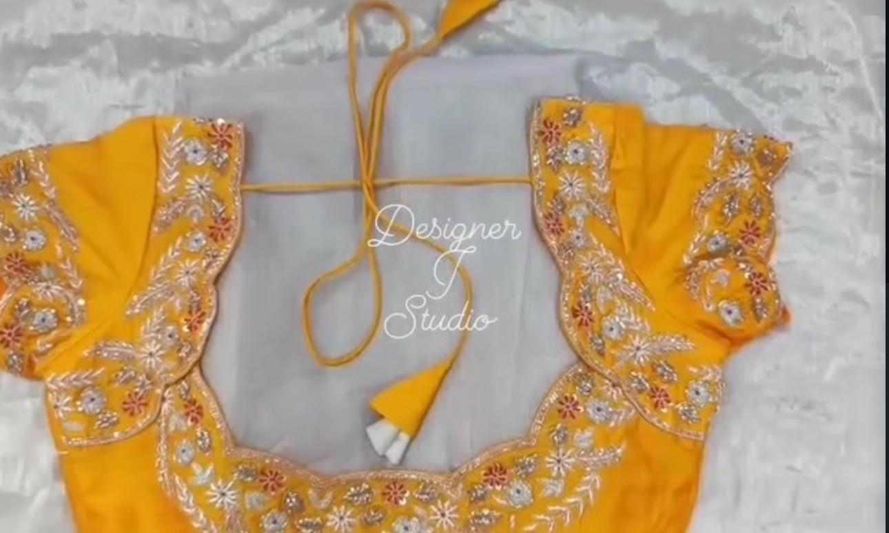 Yellow blouse with floral maggam work neck design